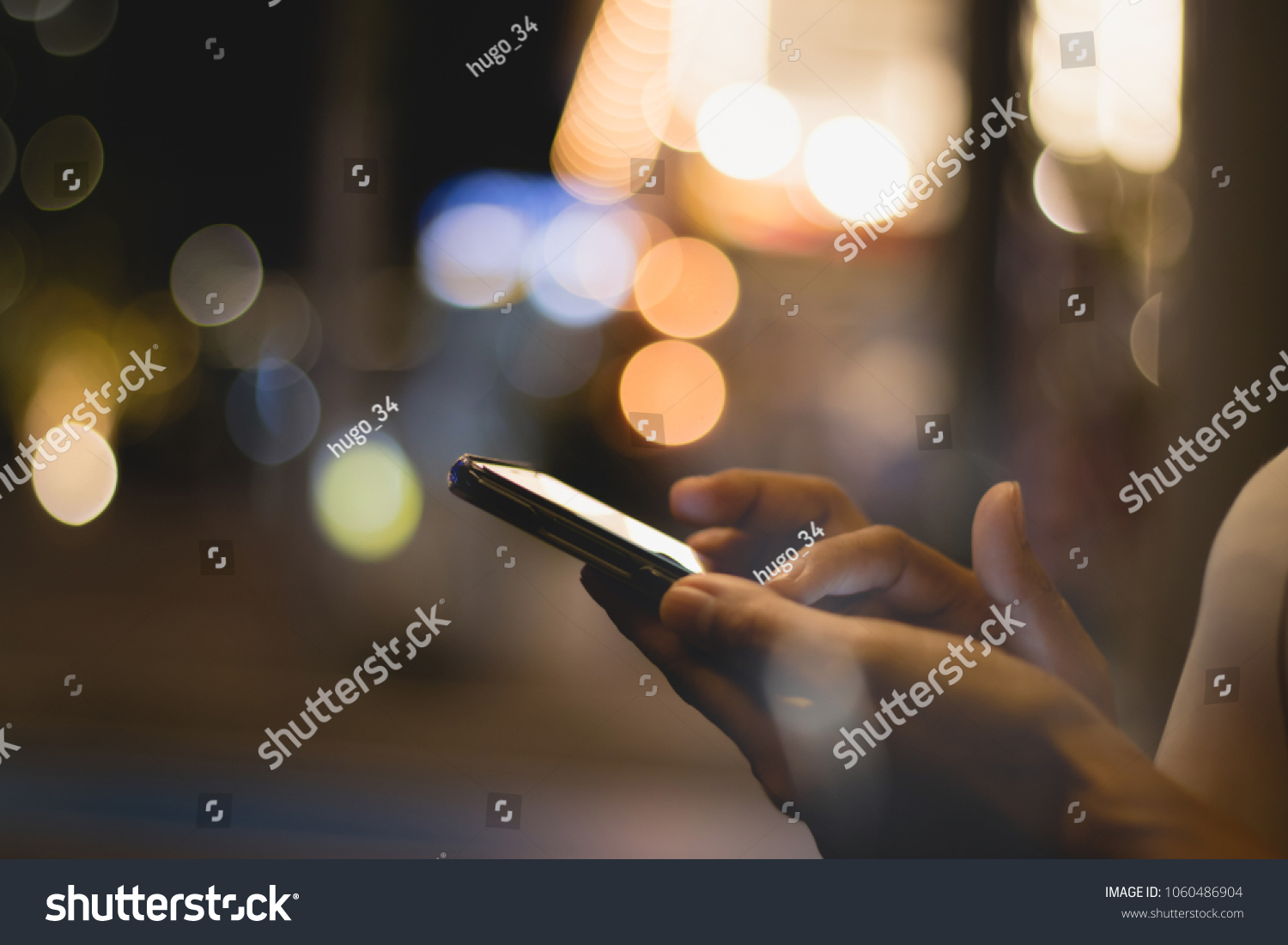 people 's hands pressing,using  mobile phone with fun and happy in the city ,bokeh background . #1060486904