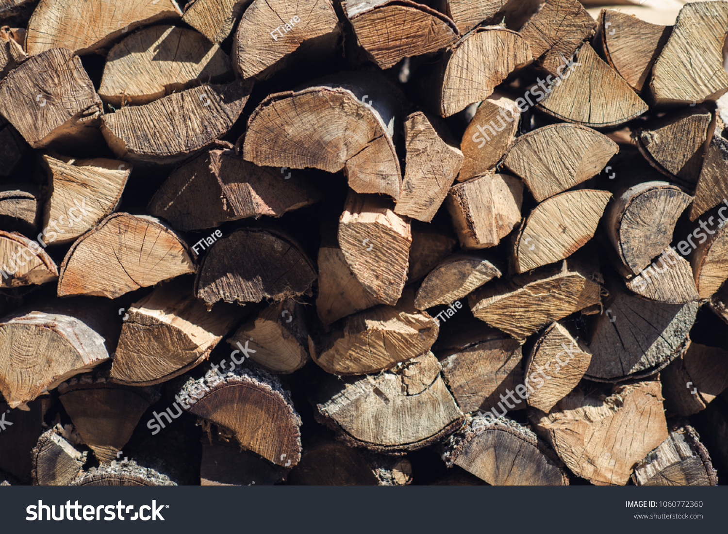 Wooden background. Firewood for the winter, stacks of firewood, pile of firewood  #1060772360