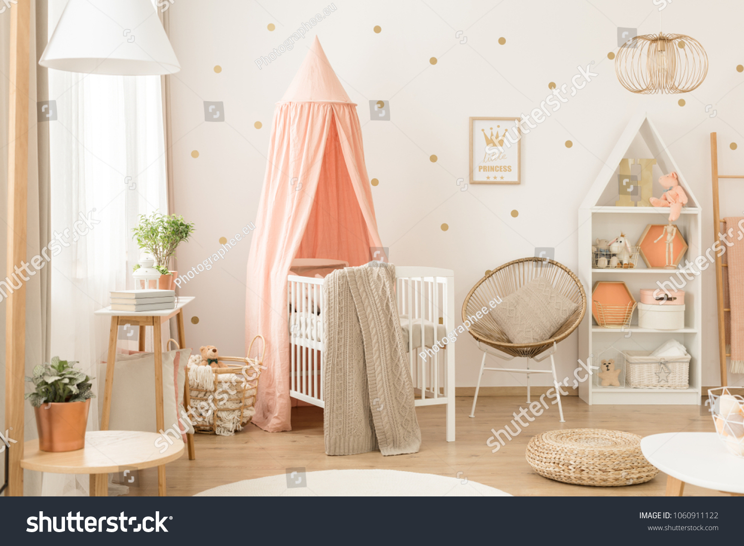 White bookcase with plush toys and decorations in a cute, cozy, white and peach pink scandinavian nursery interior #1060911122