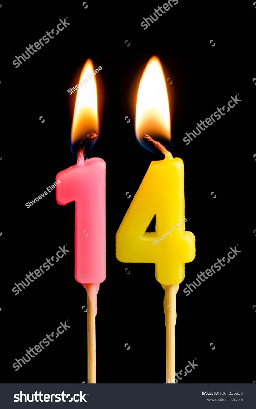 Burning candles in the form of 14 fourteen figures (numbers, dates) for cake isolated on black background. The concept of celebrating a birthday, anniversary, important date, holiday, table setting #1061236853