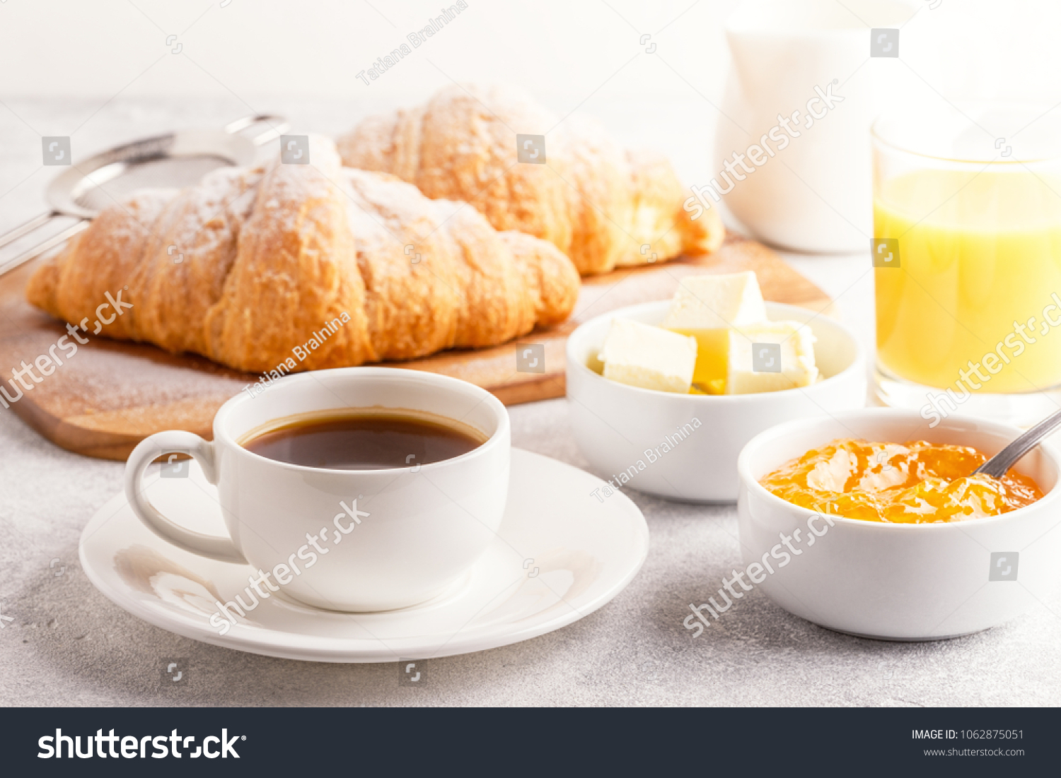 Continental breakfast with fresh croissants, orange juice and coffee, selective focuse. #1062875051