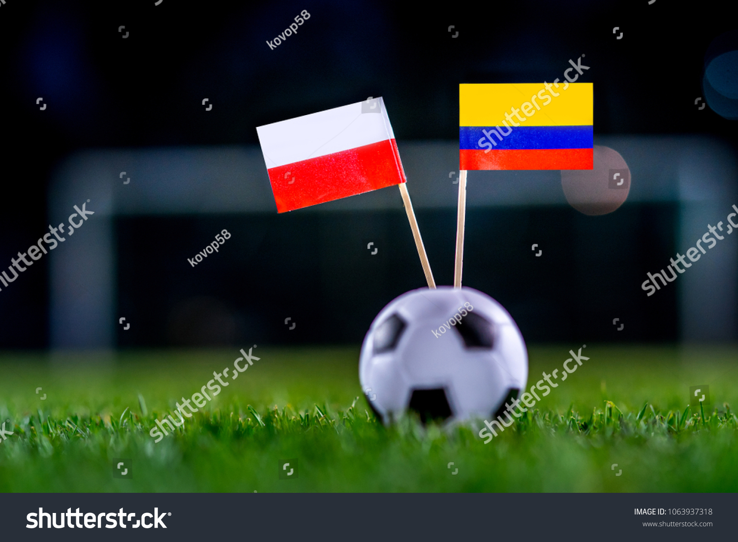 Poland - Columbia, Group H, Sunday, 24. June, Football, National Flags on green grass, white football ball on ground. #1063937318