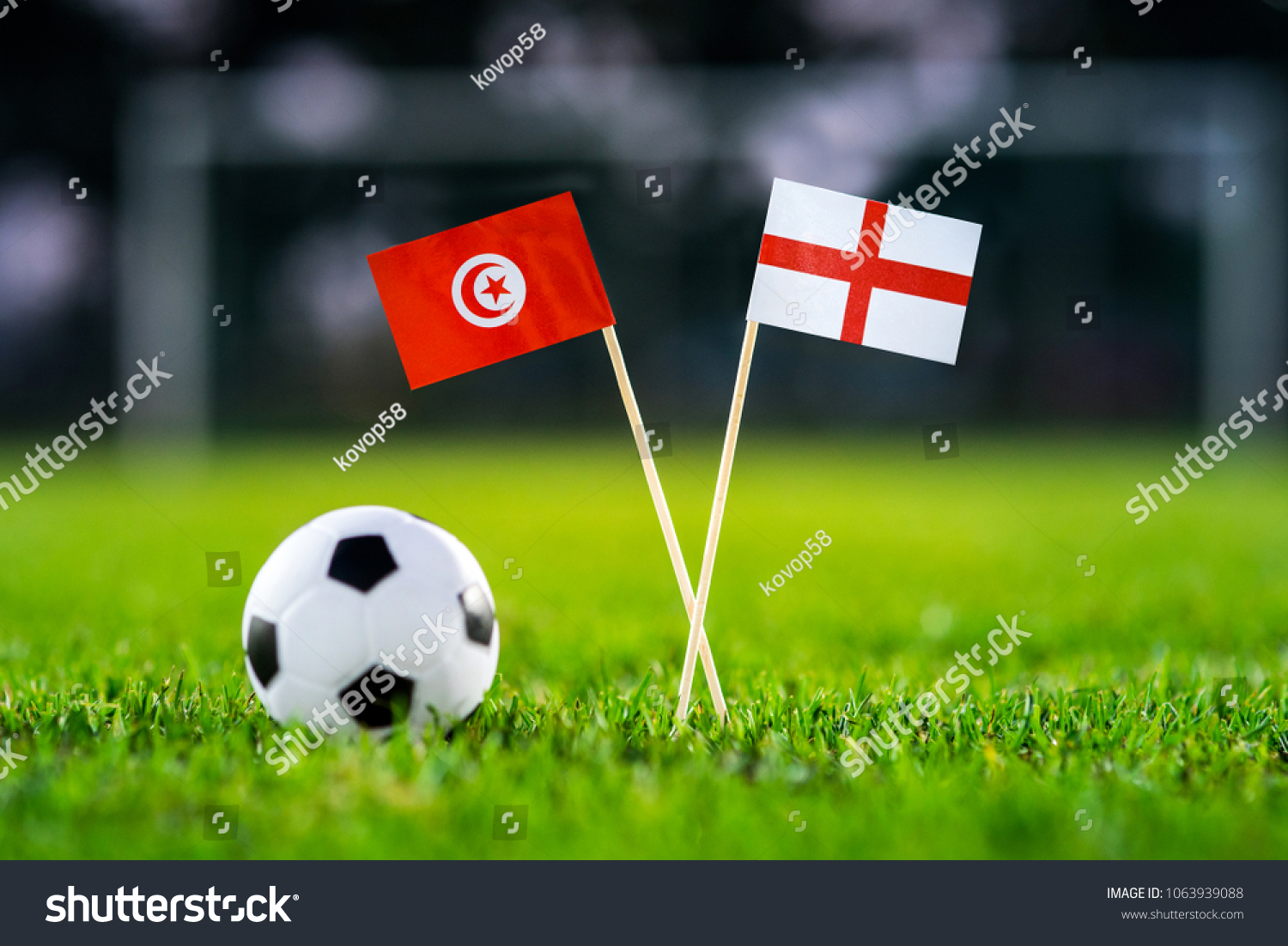 Tunisia - England, Group G, Monday, 18. June, Football, National Flags on green grass, white football ball on ground. #1063939088