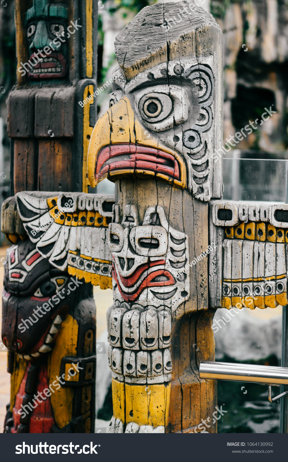 Traditional national indian totem.  Totem pole sculpture art. Ancient wooden mask.  Mayan and aztecs symbolic religious gods faces.  Ethnic pagan worship and idolatry. #1064130992