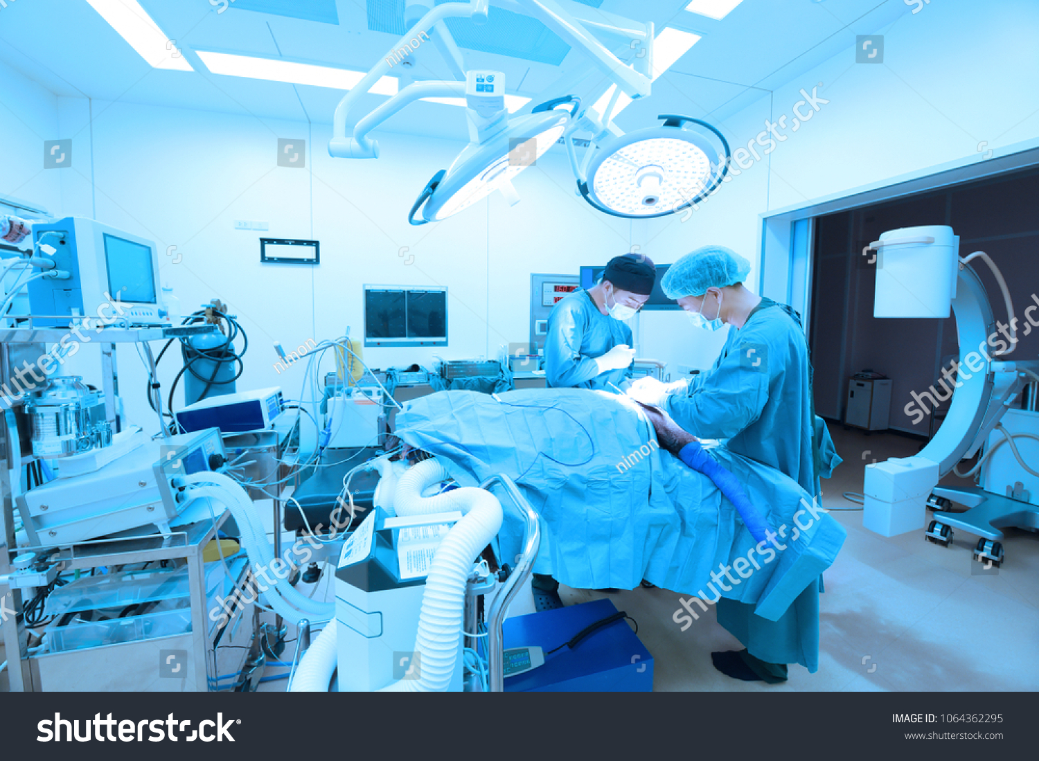 Two of veterinarian surgery in operation room take with art lighting and blue filter #1064362295