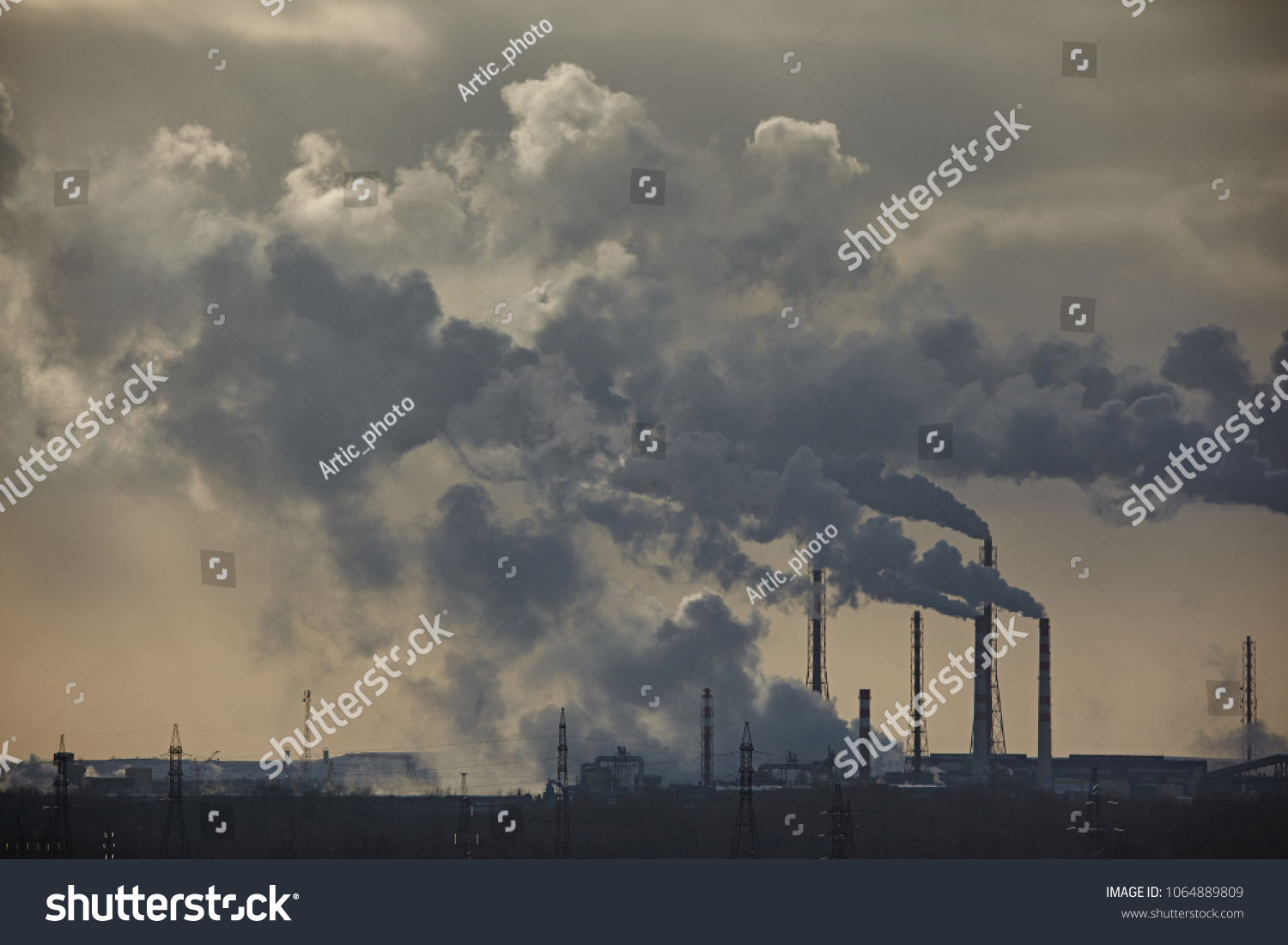 The plant emits smoke and smog from the pipes at mist cloudy, pollutants enter the atmosphere. Environmental disaster. Harmful emissions into. Exhaust gases. Chemical industry against the sky. #1064889809