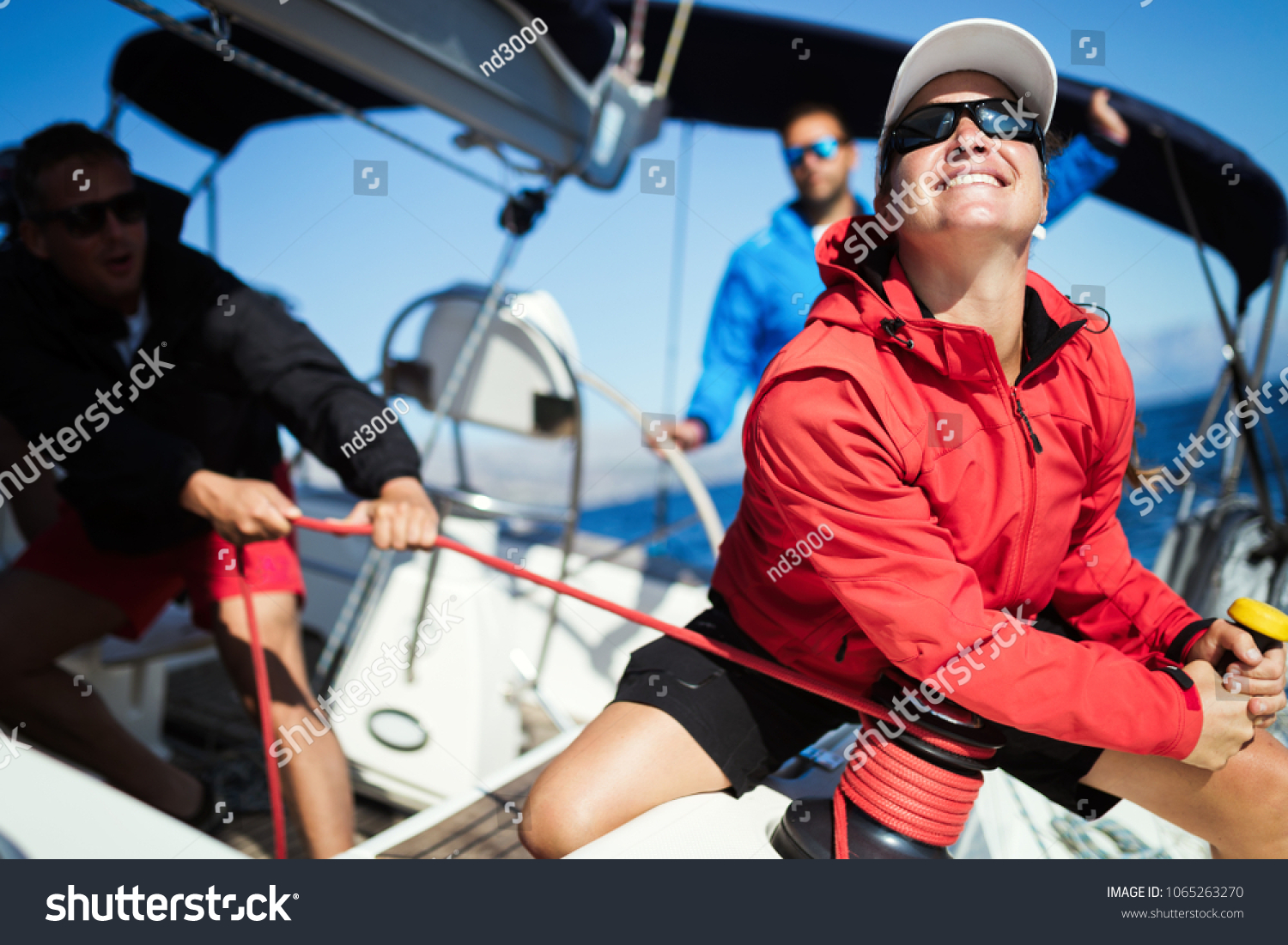 Attractive strong woman sailing with her boat #1065263270