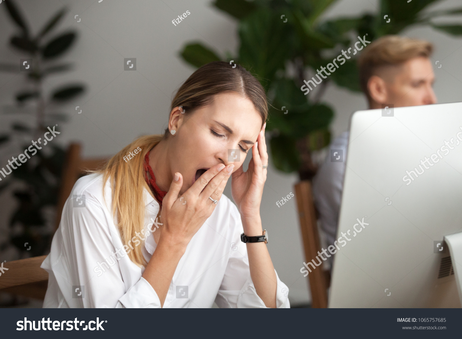 Bored businesswoman yawning at workplace feeling no motivation or lack of sleep tired of boring office routine, exhausted restless employee gaping suffering from chronic fatigue or overwork concept #1065757685