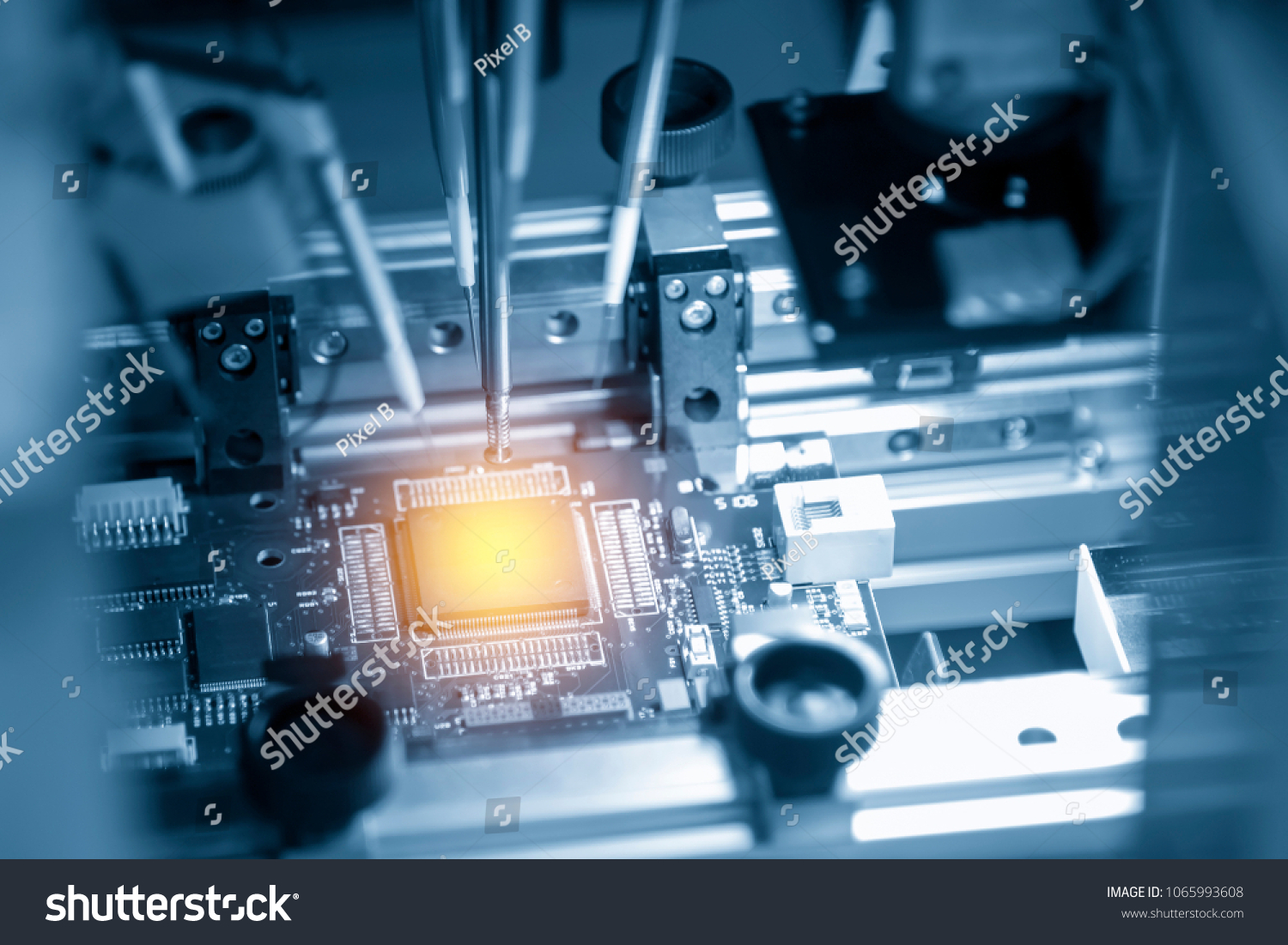 The microchip on the main board in the assembly line in the light blue scene with lighting effect, computer part manufacturing concept. #1065993608