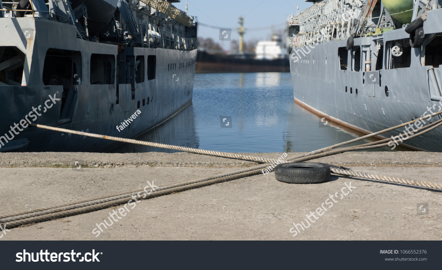 ropes crosswise at the background of two ships and canal. #1066552376