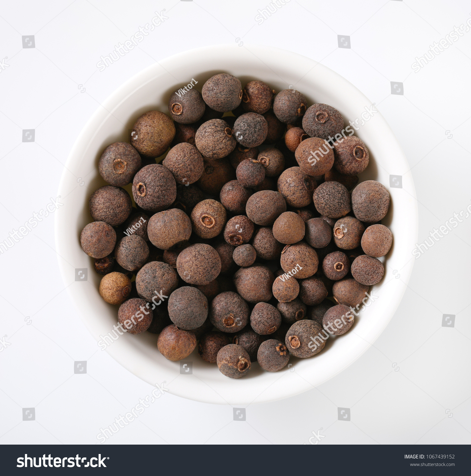 bowl of allspice berries on white background #1067439152