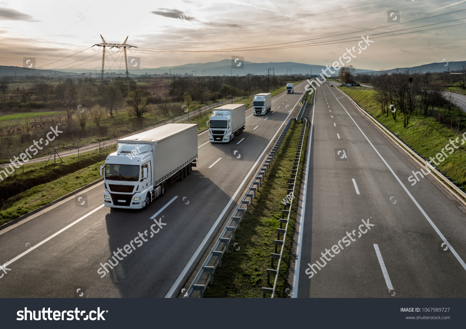 Caravan or convoy of trucks in line on a country highway #1067989727