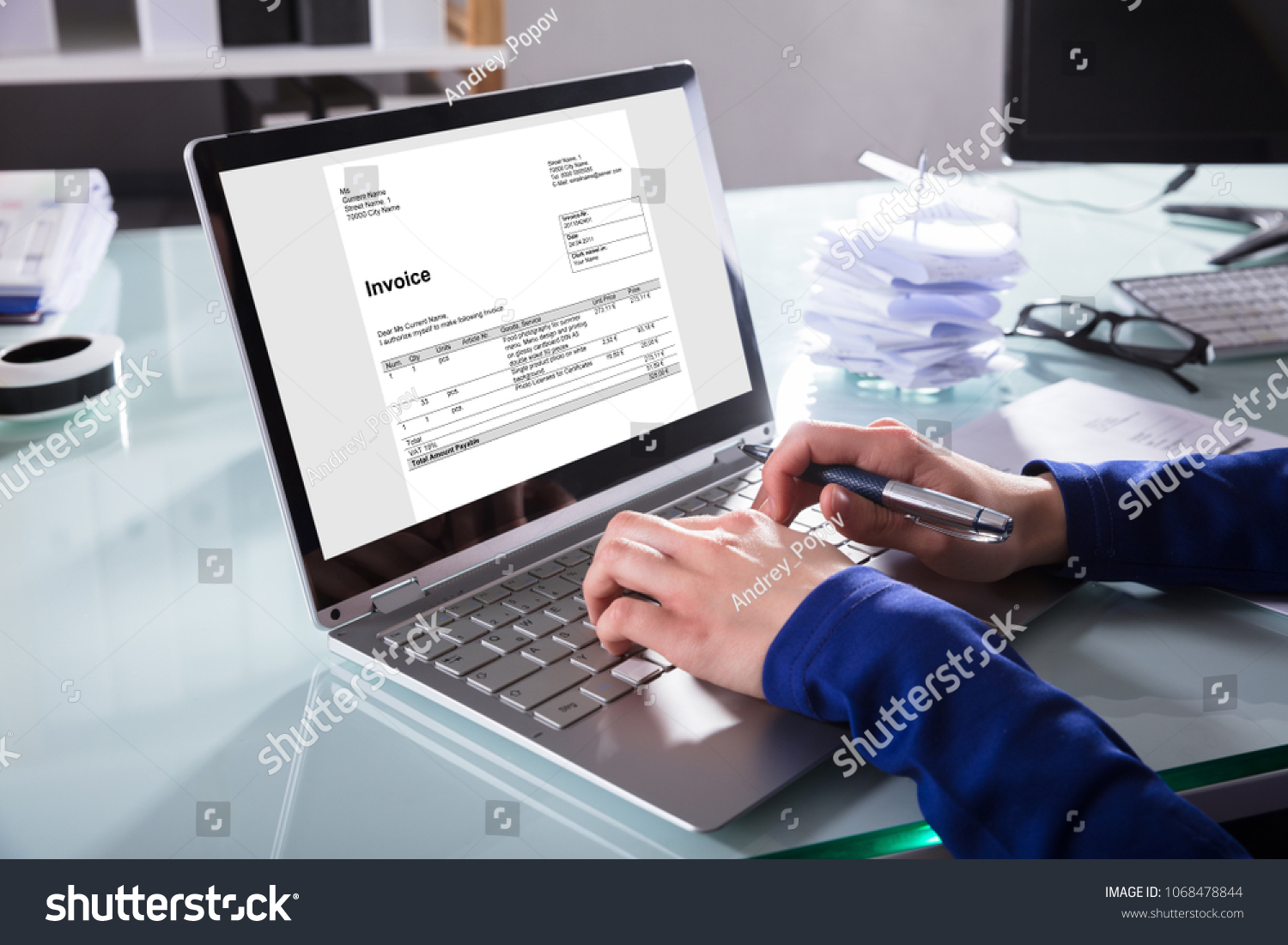 Close-up Of A Businessperson's Hand Analyzing Invoice On Laptop At Workplace #1068478844