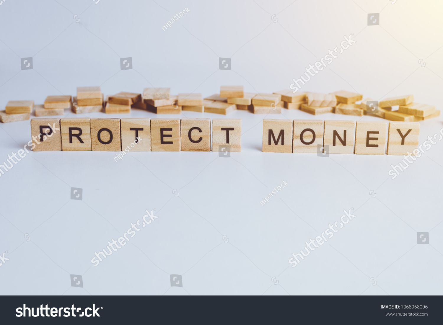 Words PROTECT MONEY made with block wooden letters. Wood abc. on white table #1068968096