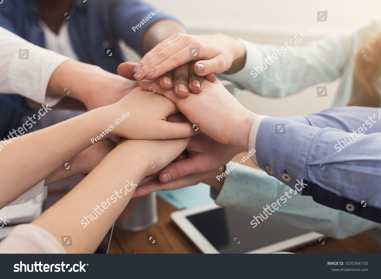 Multiethnic team put hands together, connection, teambuilding and alliance concept. Crop of people in office unite for teamwork and cooperation, copy space #1070366150
