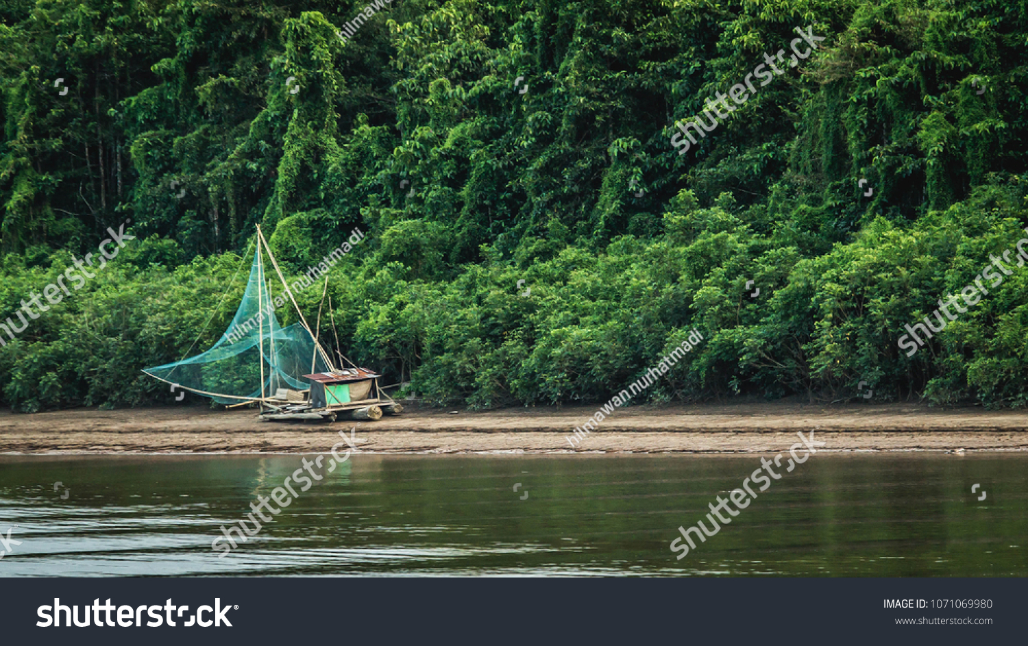 traditional fisherman boat on Mahakam riverbank, Borneo, Indonesia #1071069980