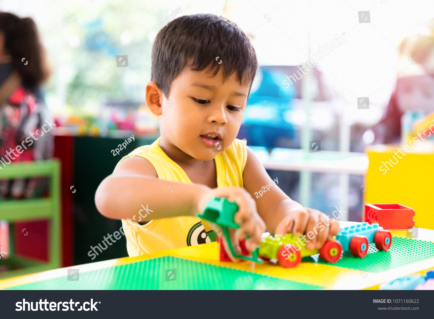 A cute child playing with color toy indoor #1071160622