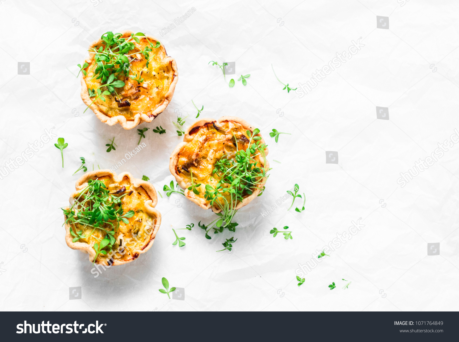 Mini savory pie with chicken, leek, cheese on light background, top view. Delicious appetizer, snack, breakfast, tapas #1071764849
