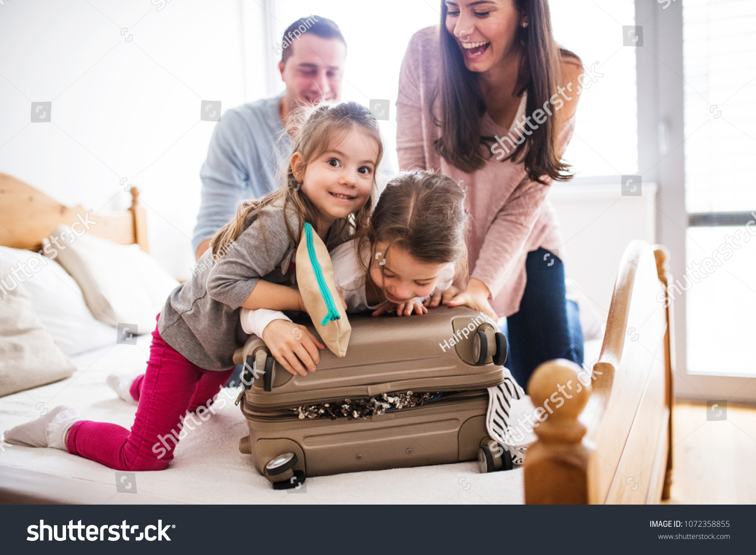 Young family with two children packing for holiday. #1072358855