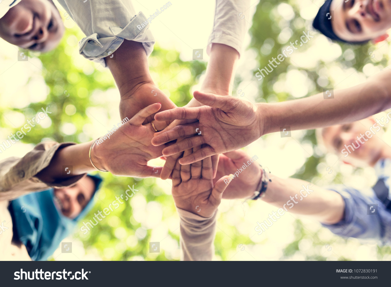 Group of diverse youth with teamwork joined hands #1072830191