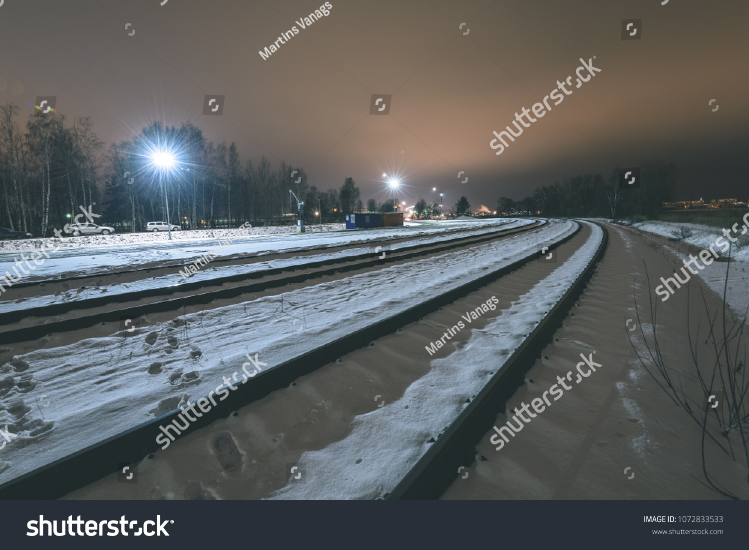 Night photography long exposure. Riga, Latvia industrial port details over frozen river of Daugava. railroad tracks - vintage retro look #1072833533