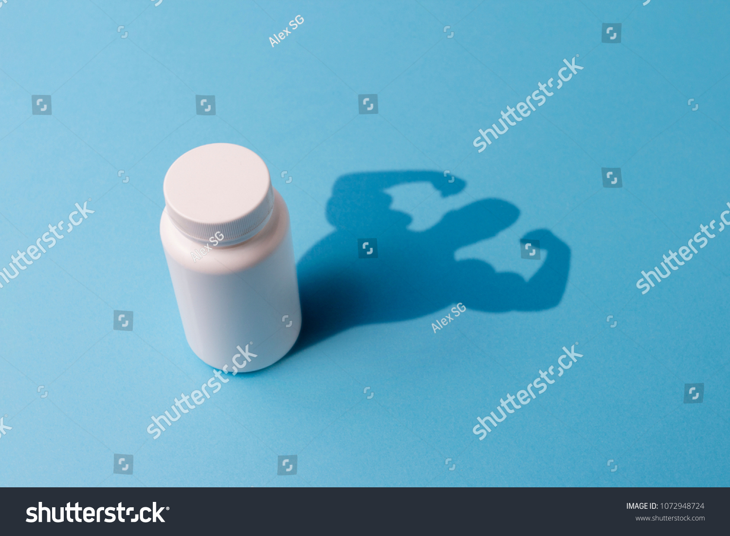 Plastic Bottle with Tablets and the Shadow with the Hands of the Bodybuilder. Concept of Steroids and Pharmaceutical Preparations for Bodybuilders. Pharmaceutical Preparations for rapid muscle growth. #1072948724