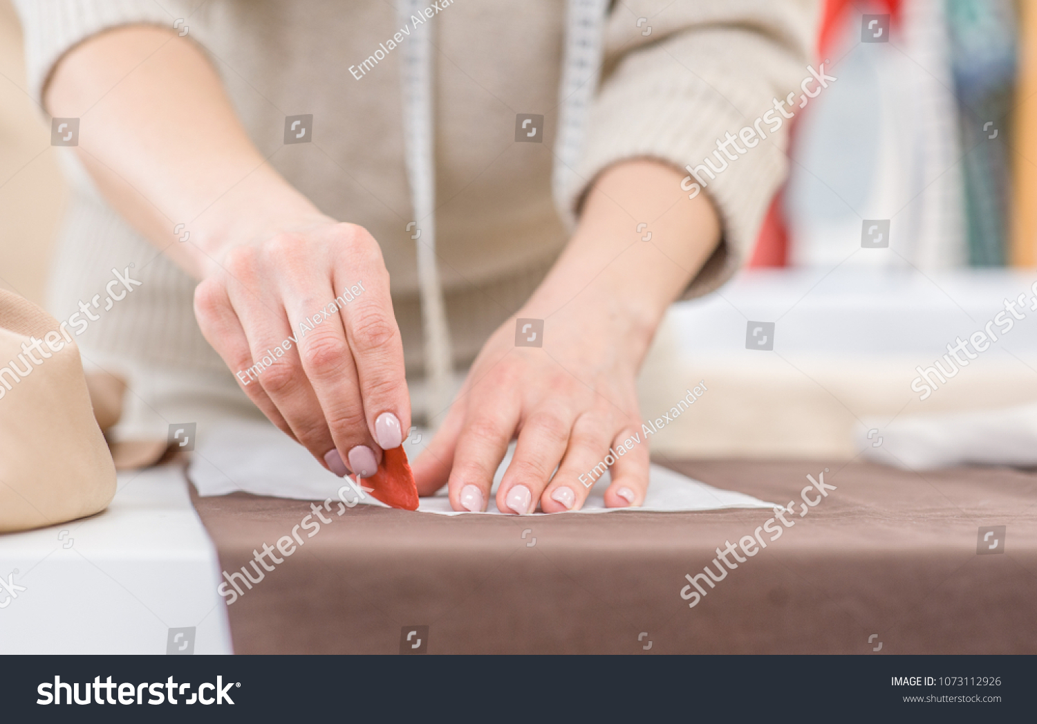 Close up woman draws with soap markup patterns on  fabric #1073112926