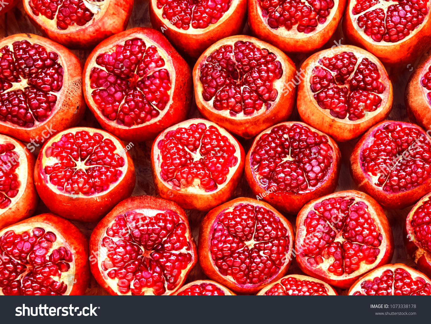 many pomegranate  cut in half, pomegranate background #1073338178