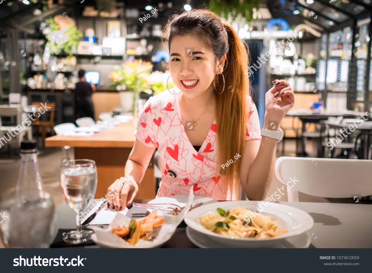 Young asian woman eating thai food at restaurant #1073610059