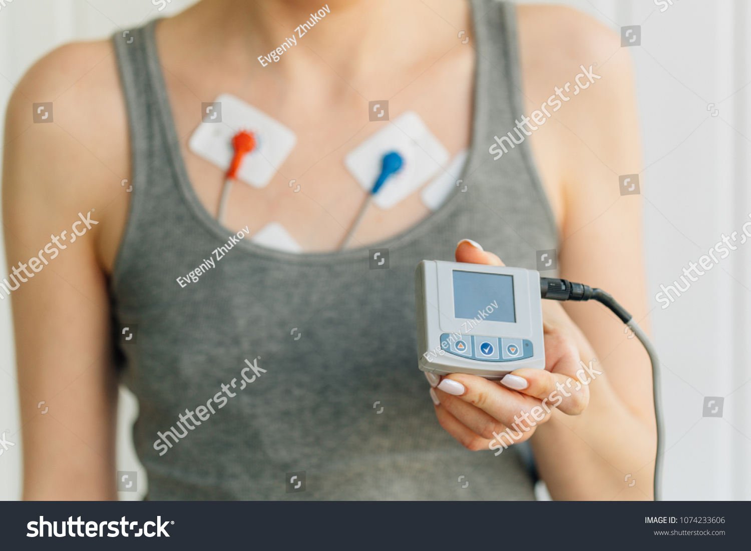 Woman wearing holter monitor device for daily monitoring of an electrocardiogram. Treatment of heart diseases #1074233606