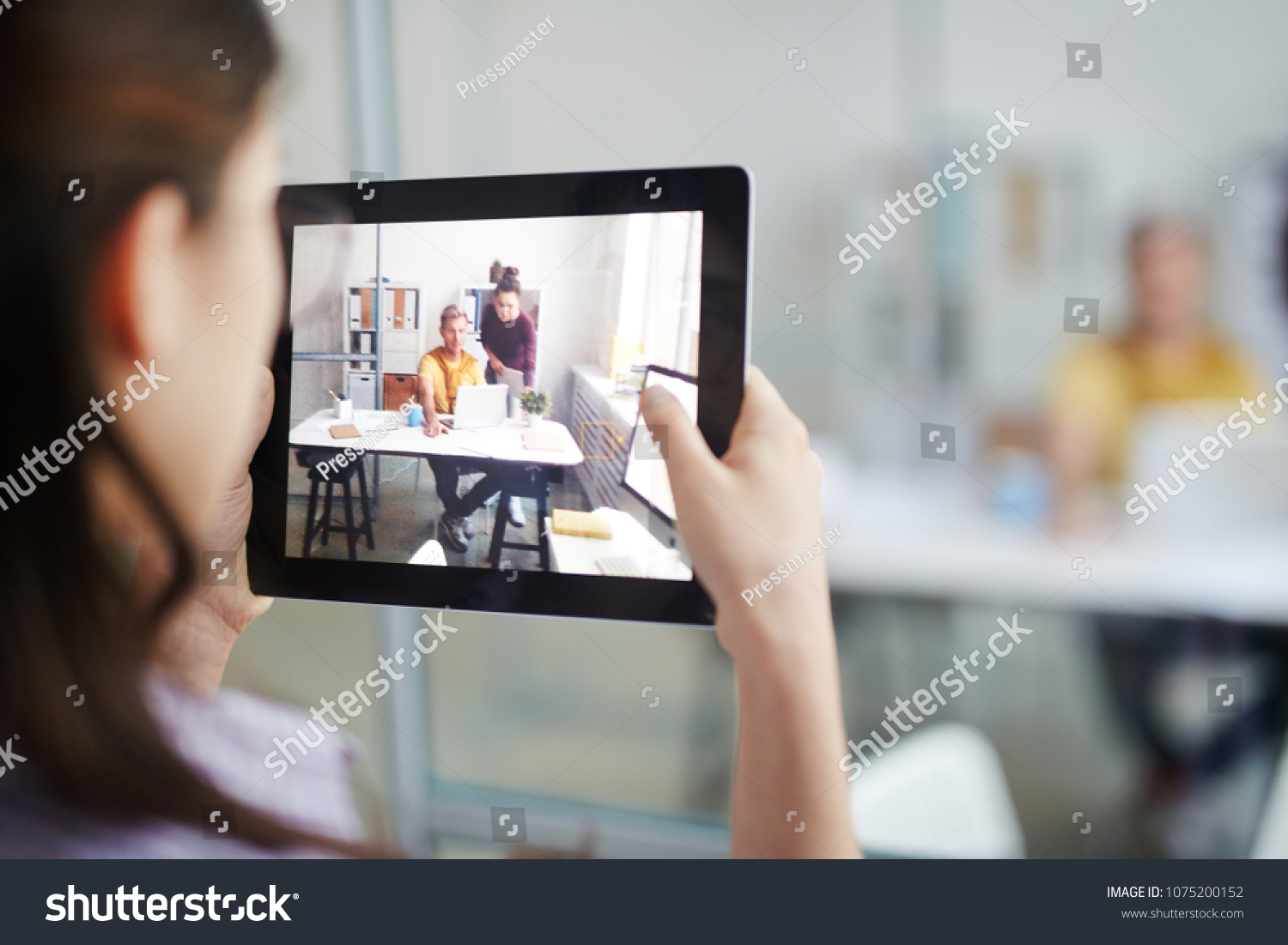 Businesswoman shoot her colleagues on video on her digital tablet #1075200152