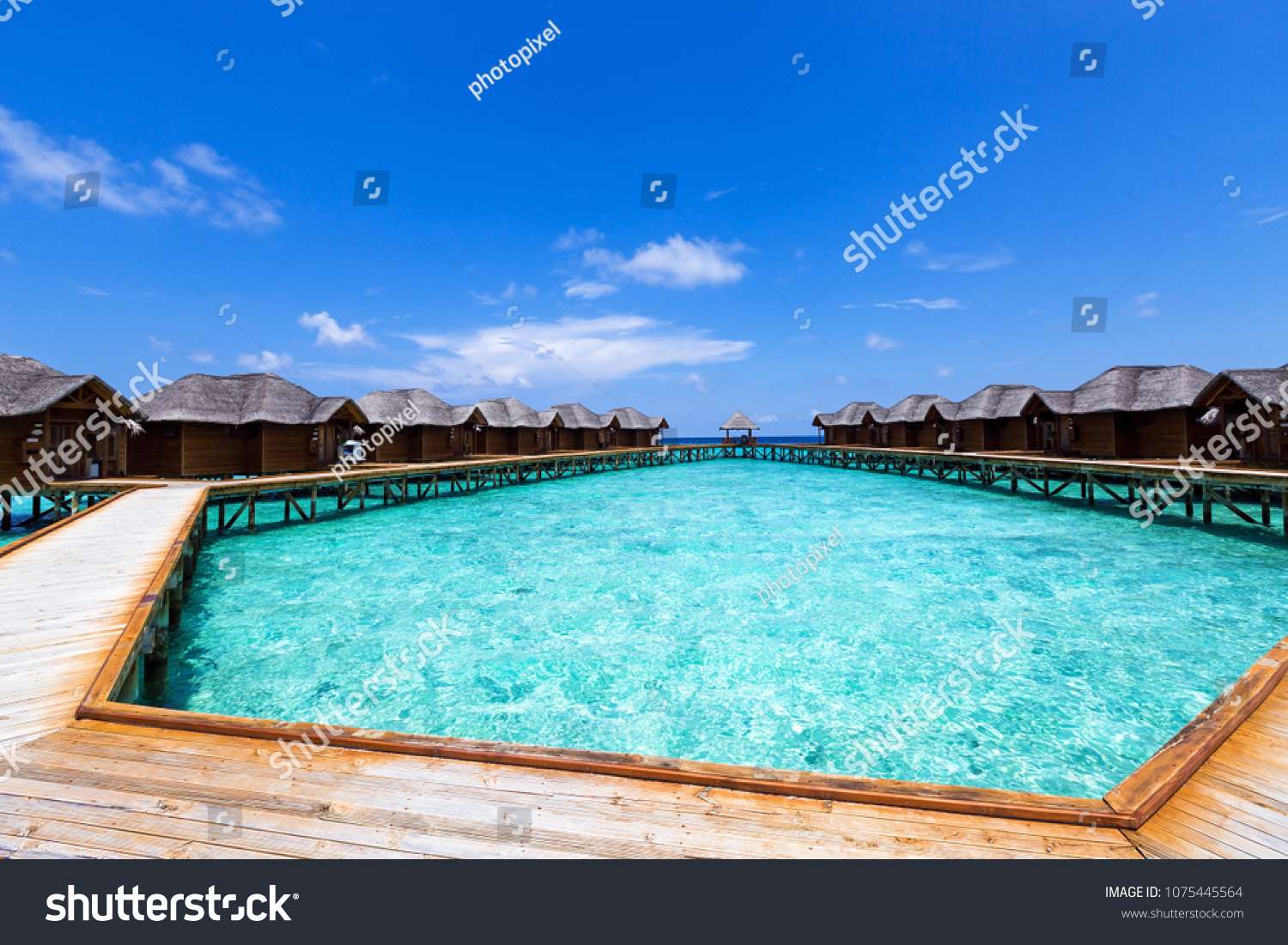 Tropical travel card with pristine beach and water bungalows at maldivian island #1075445564