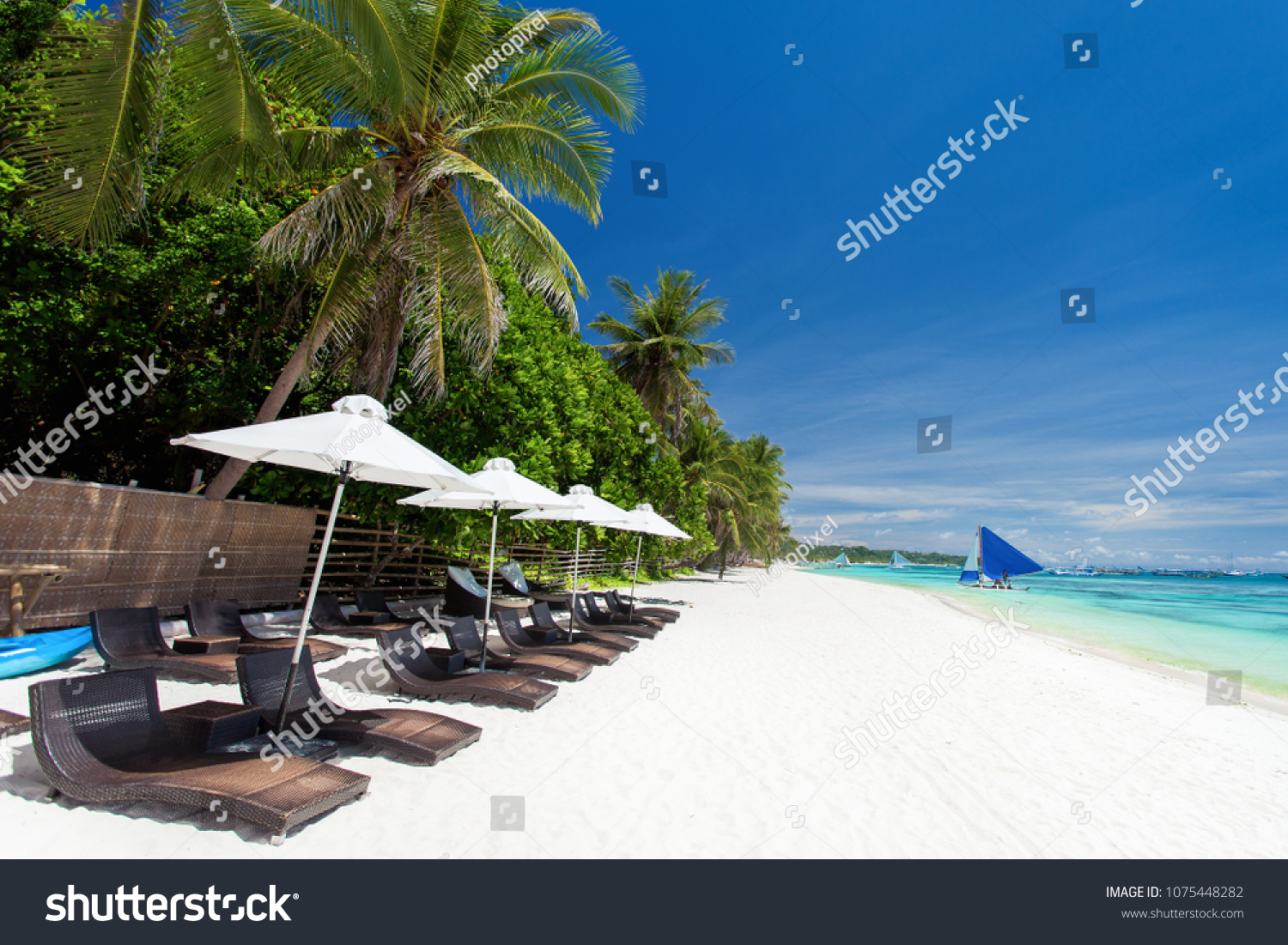 Sun umbrellas and beach chairs on tropical coastline, Philippines, Boracay
 #1075448282