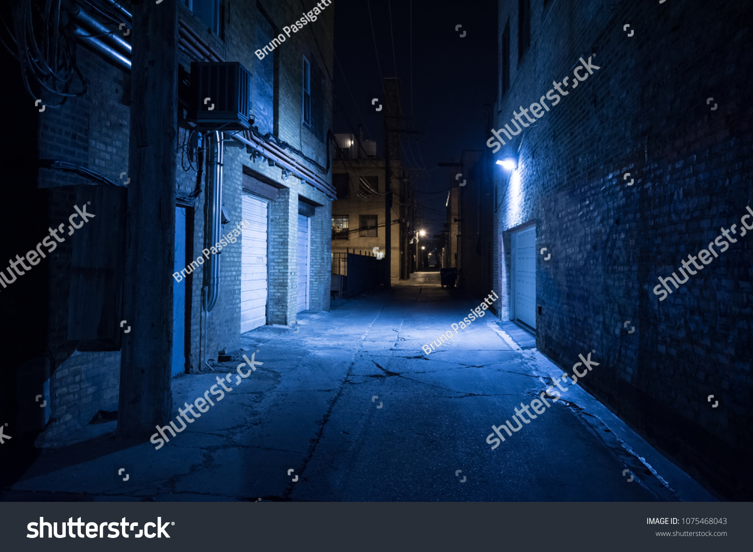 Dark and eerie urban city alley at night #1075468043