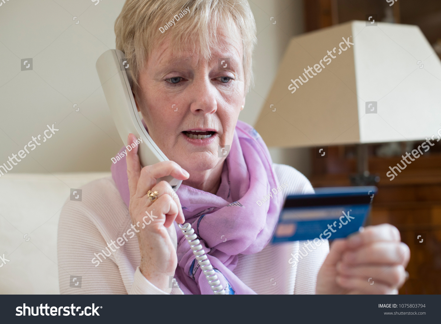 Senior Woman Giving Credit Card Details On The Phone #1075803794