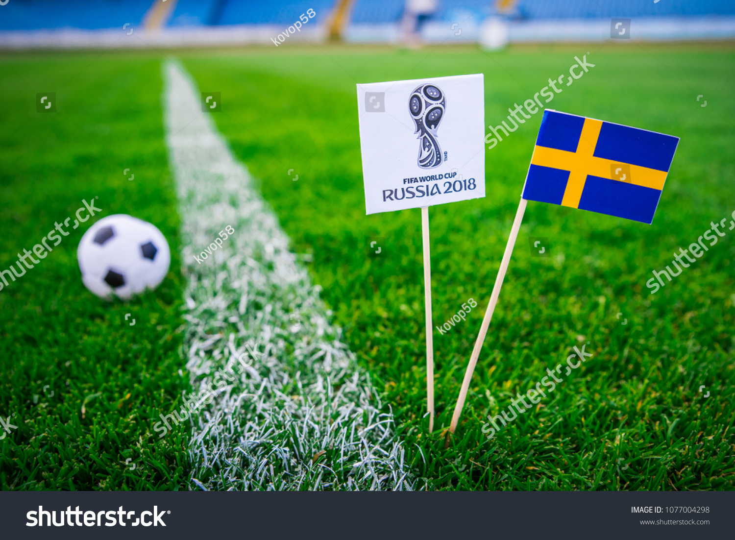 MOSCOW, RUSSIA - APRIL, 24, 2018: Sweden national flag and Official logo of Football FIFA World Cup 2018 in Russia. #1077004298