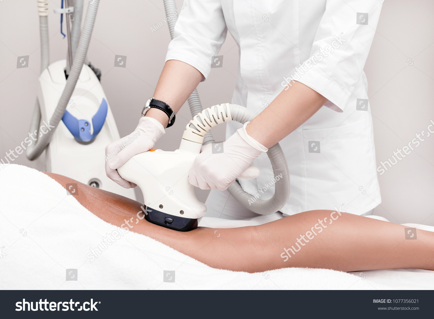 Ultrasound cavitation body contouring treatment. Woman getting anti-cellulite and anti-fat therapy on her leg in beauty salon. #1077356021