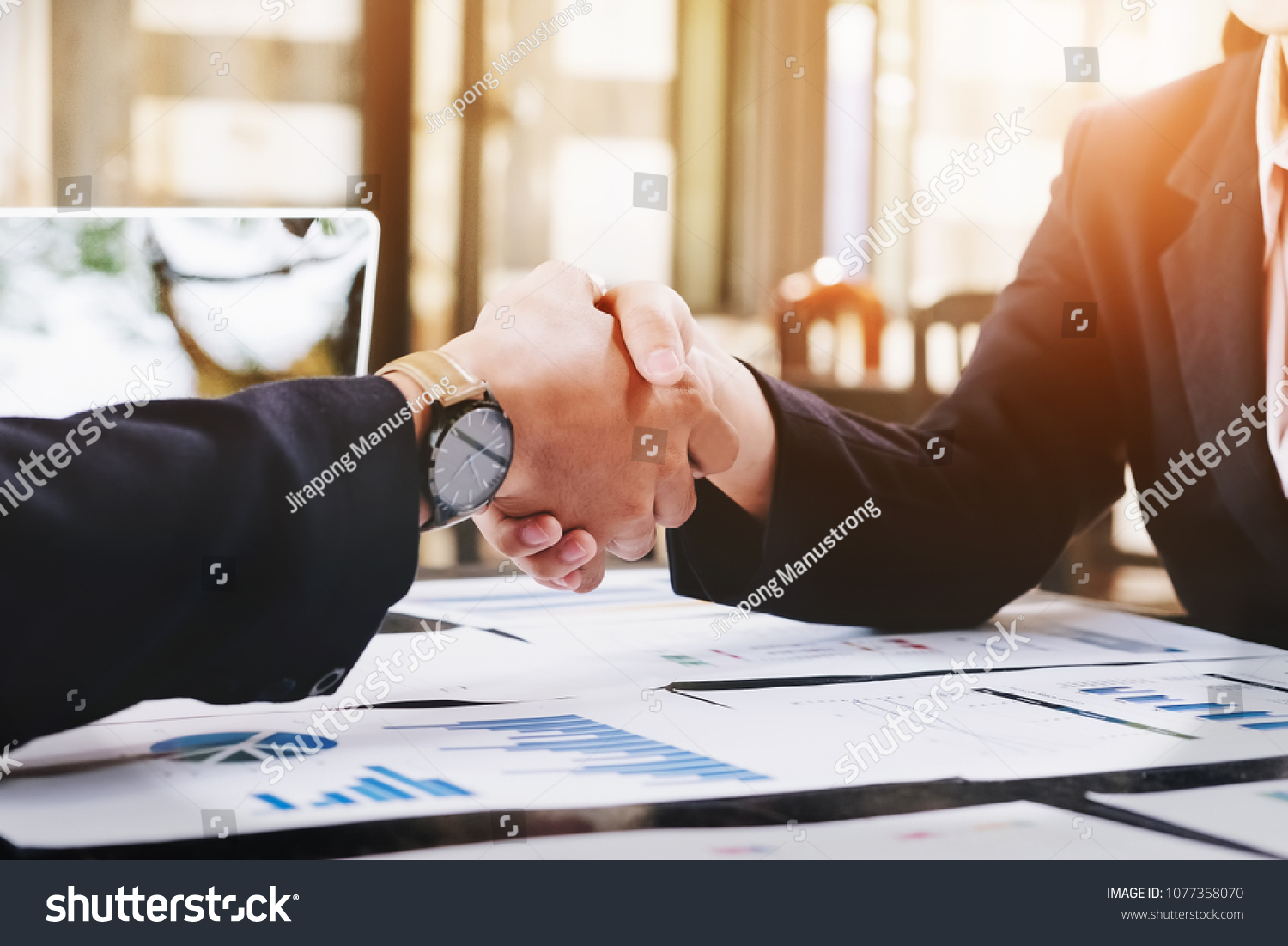 Sealing a deal, Business man and woman handshake  to business  agreement. #1077358070