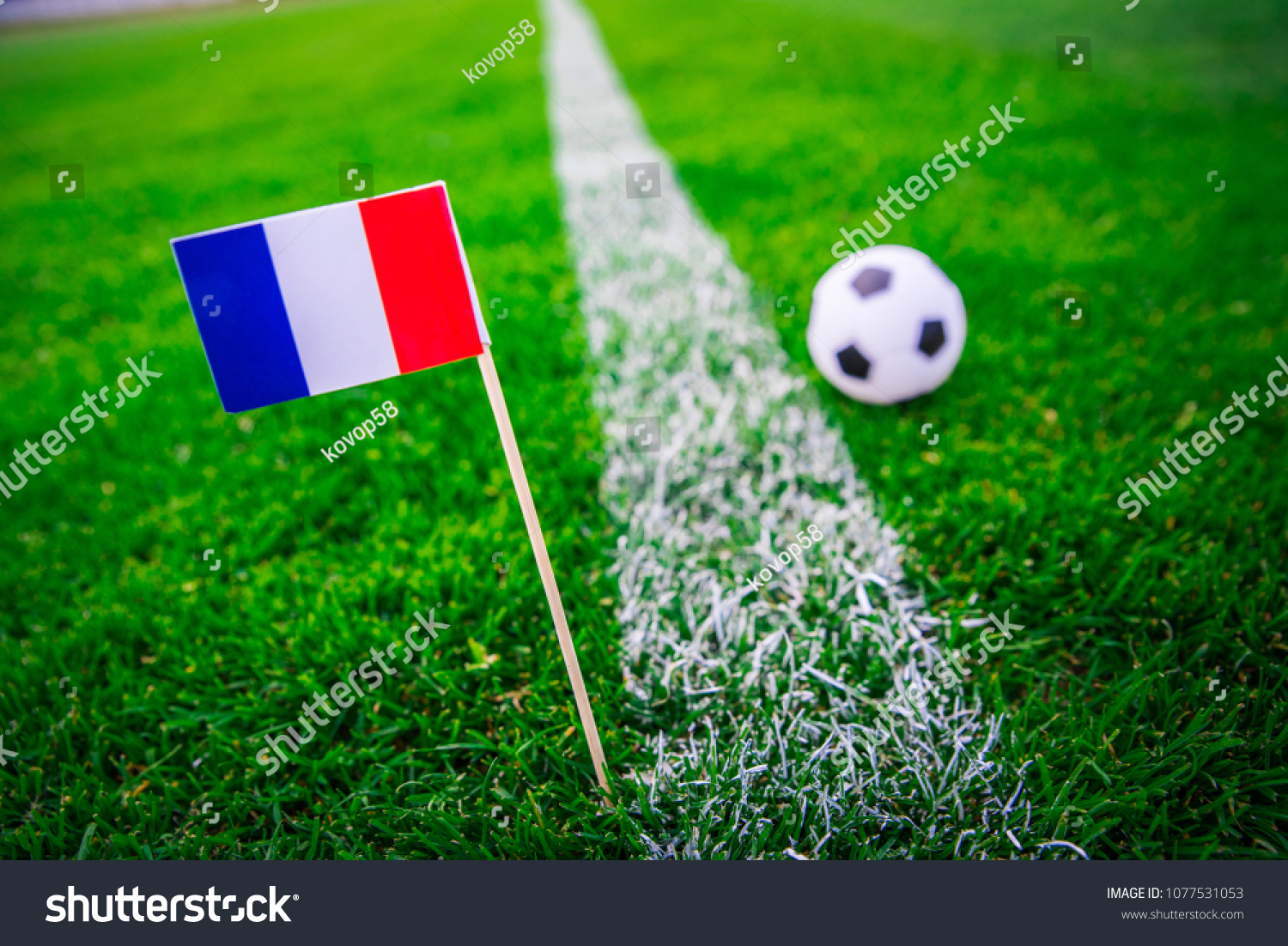 France national Flag and football ball on green grass. Fans, support photo, edit space.  #1077531053