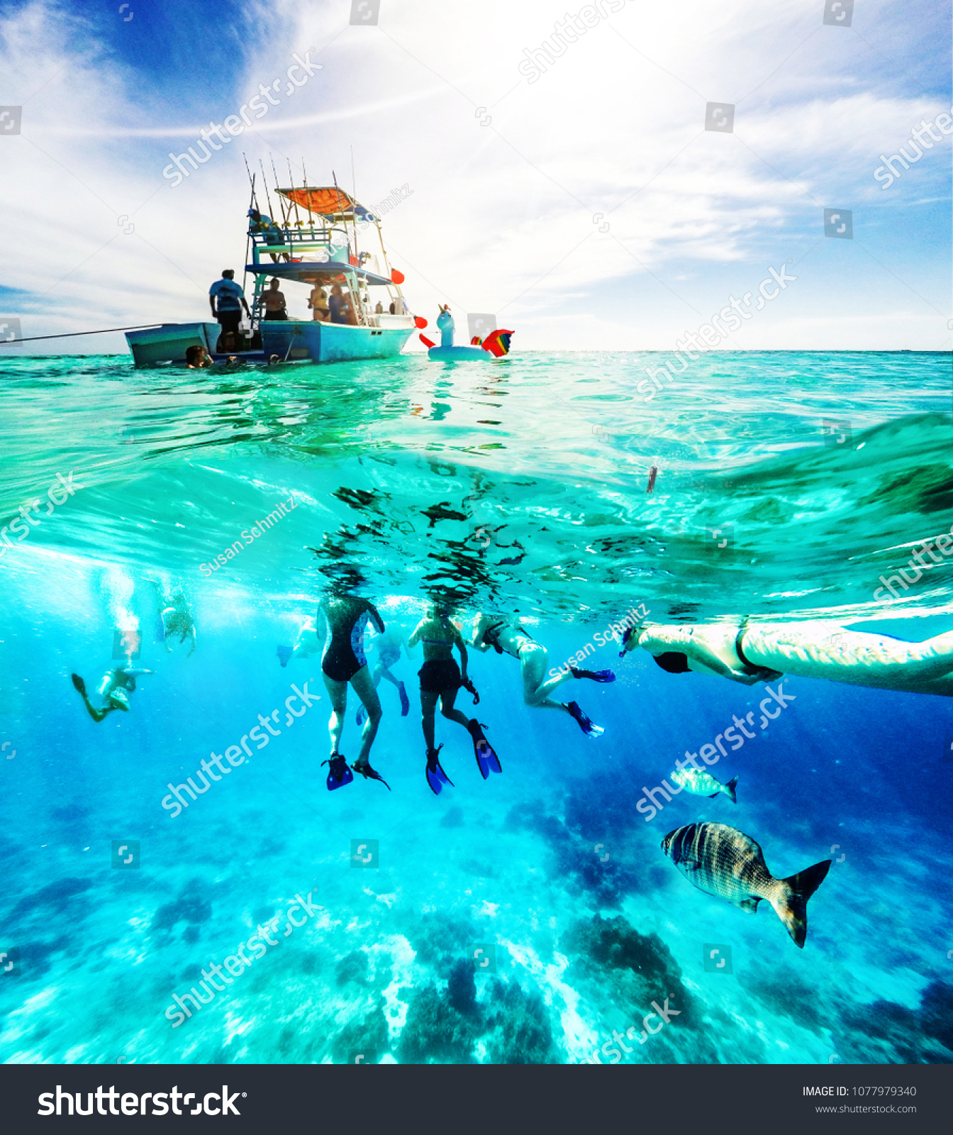 Group of friends on a Carribean Sea adventure with party boat, snorkeling and scuba diving #1077979340