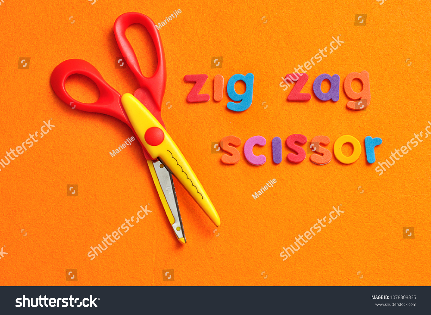 A zigzag scissor with the words zigzag scissor on an orange background #1078308335