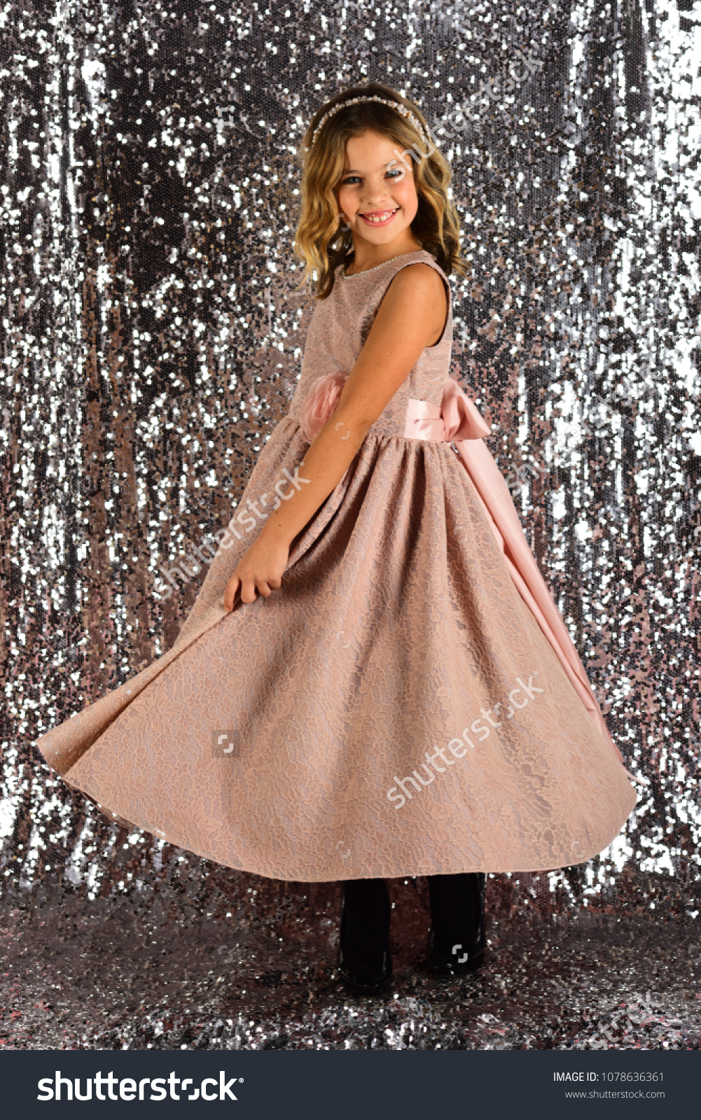 Child girl in stylish glamour dress, elegance. Fashion model on silver background, beauty. Fashion and beauty, little princess. Look, hairdresser, makeup. Little girl in fashionable dress, prom. #1078636361
