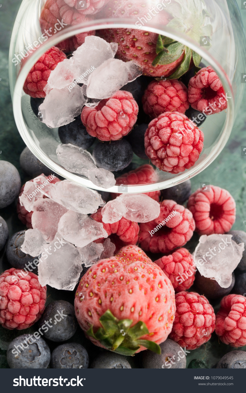 Closeup shot of frozen raspberries, blackberries and strawberries #1079049545