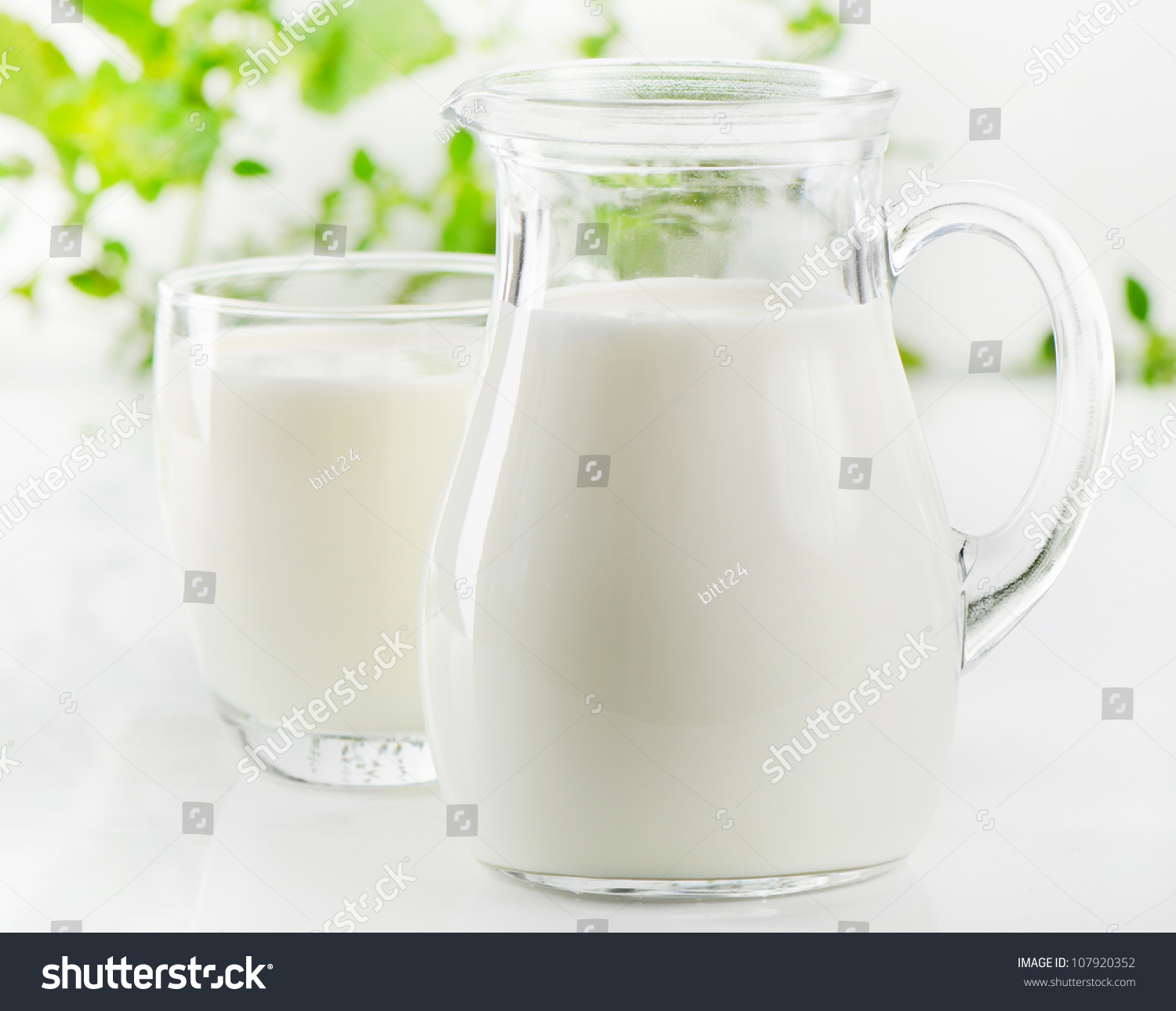Glass jug and glass with milk #107920352