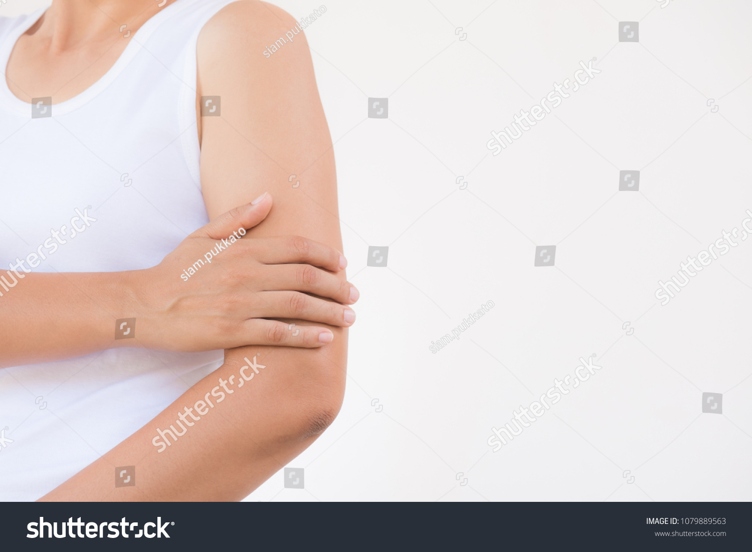 Closeup female's arm. Arm pain and injury. Health care and medical concept. #1079889563