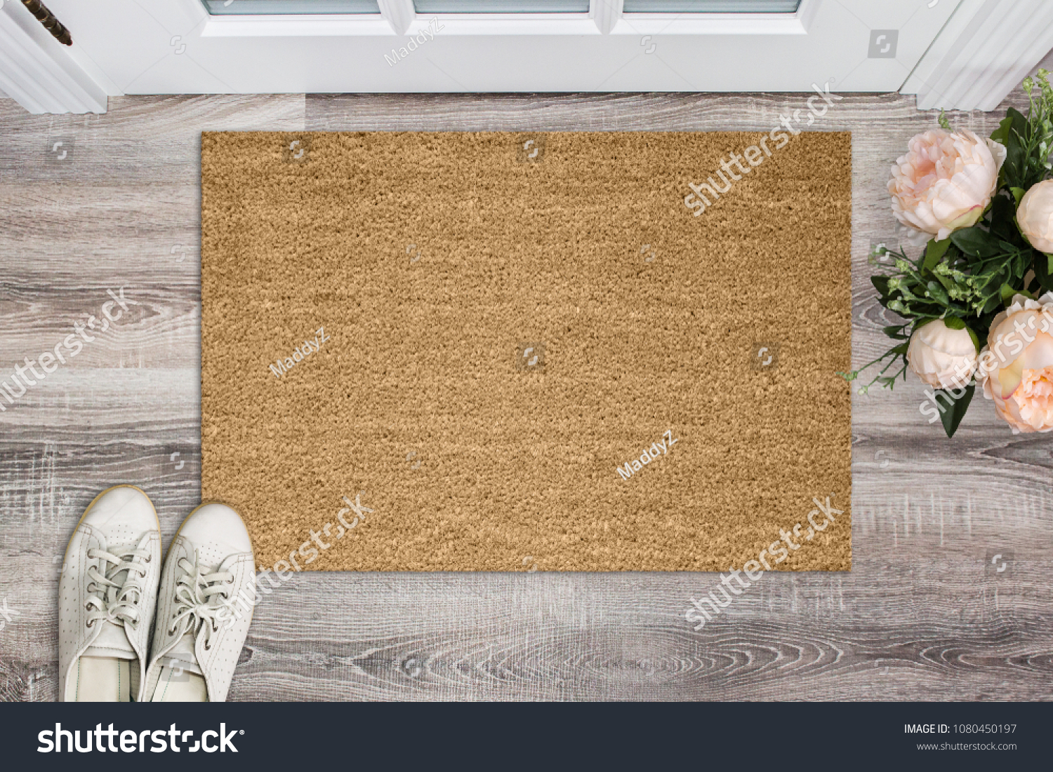 Blank coir doormat before the door in the hall. Mat on wooden floor, flowers and shoes. Welcome home, product Mockup #1080450197