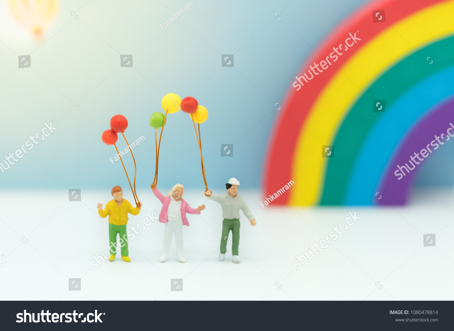 Miniature family with balloon and rainbow  using as background international family day concept. #1080478814