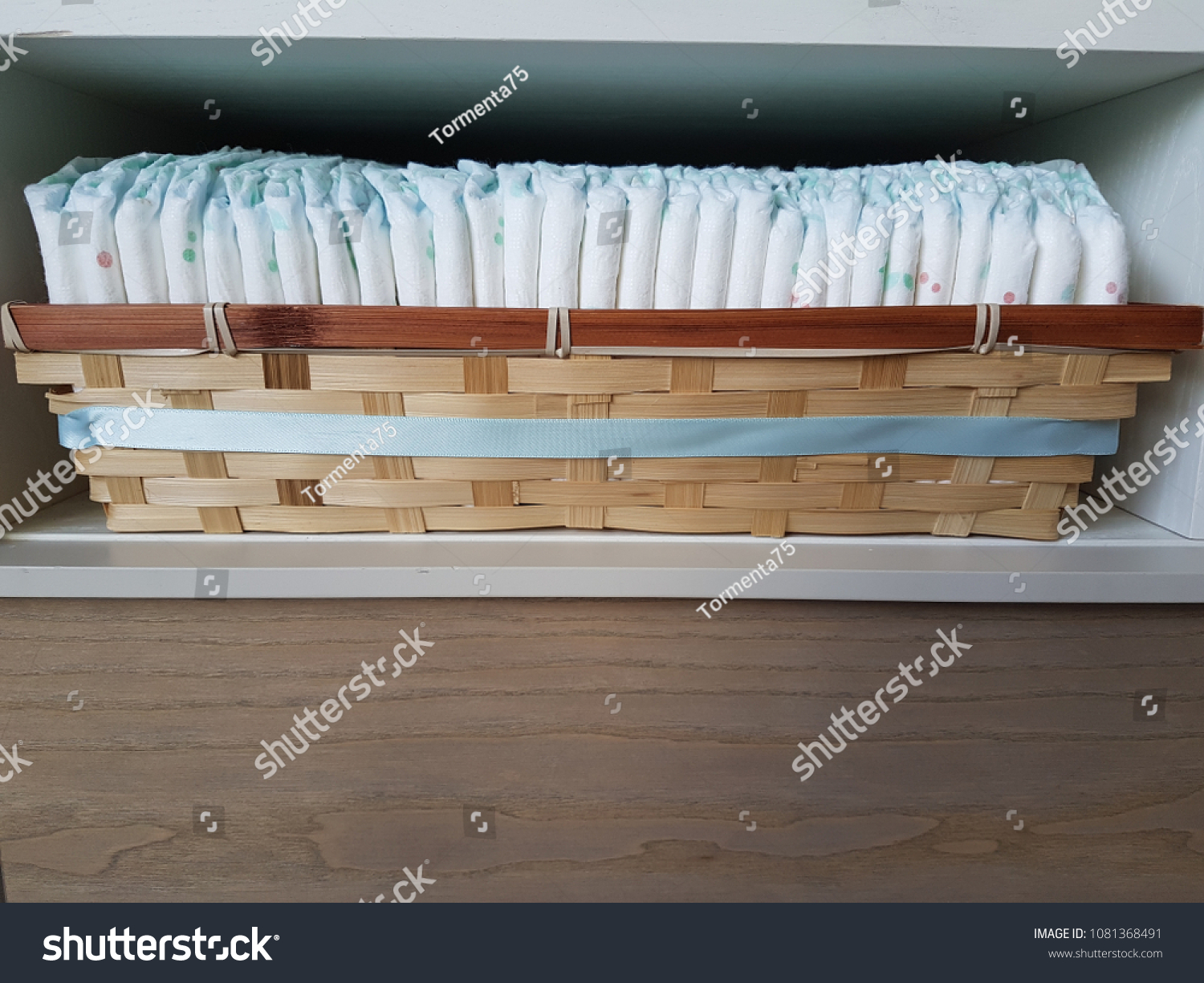 Basket with disposable baby diapers on wooden background. 
Copy space


 #1081368491