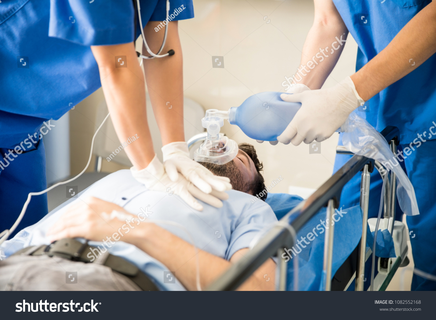 Hands of doctors giving cardiac massage and Royalty Free Stock Photo