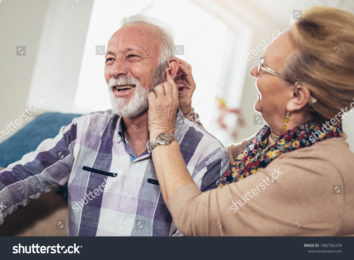 Older man and woman or pensioners with a hearing problem #1082782478